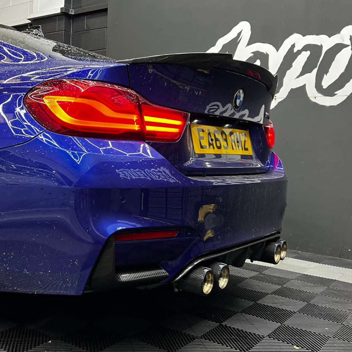 BMW M3 and M4 F80, F82, F83 carbon fibre rear bumper canards by CT Carbon, showing sleek aerodynamic enhancements.