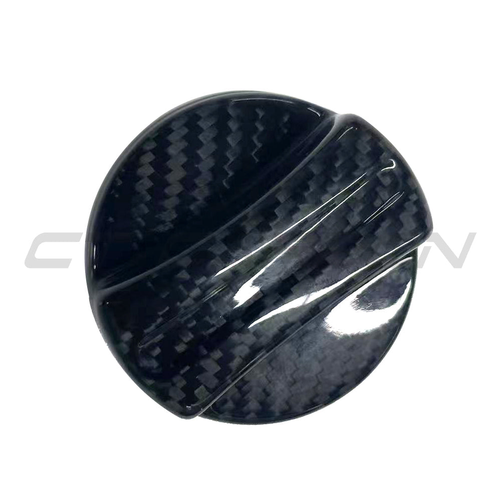 BMW 2010+ carbon fiber fuel cap cover by CT Carbon, close-up of sleek, black carbon fiber accessory on vehicle fuel tank.
