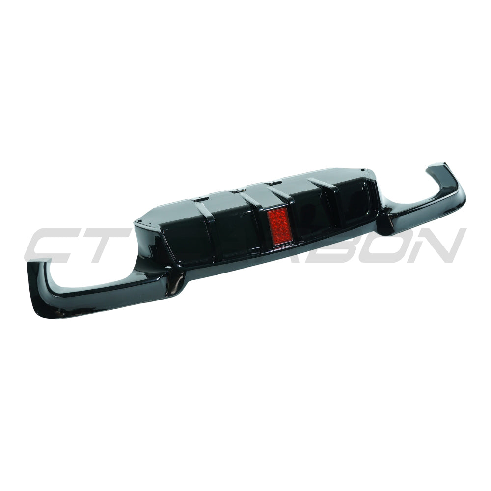 BMW 5 Series F10/F11 2011-2017 CT Carbon gloss black diffuser with quad tips and LED accents, mounted on the rear of the vehicle.