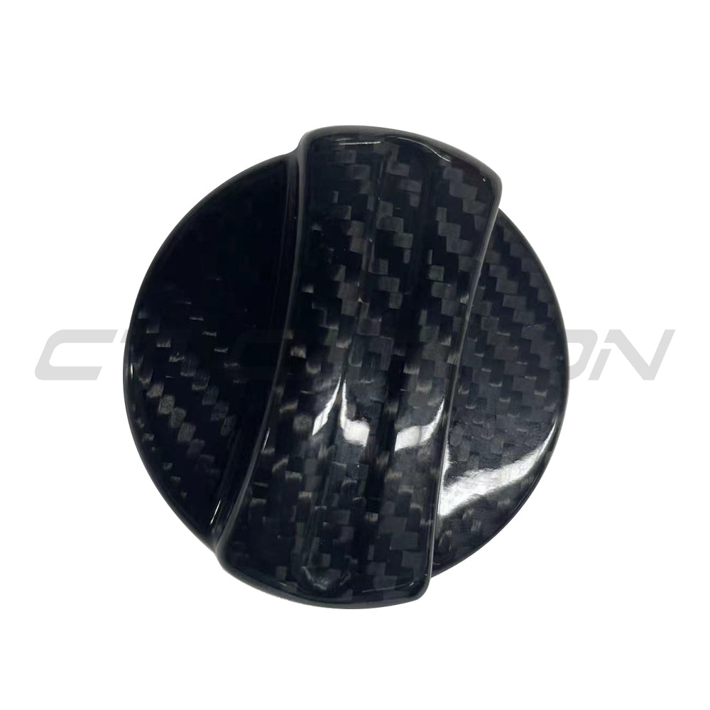 BMW 2010+ carbon fiber fuel cap cover by CT Carbon, close-up of sleek black accessory fitting over the fuel tank opening.