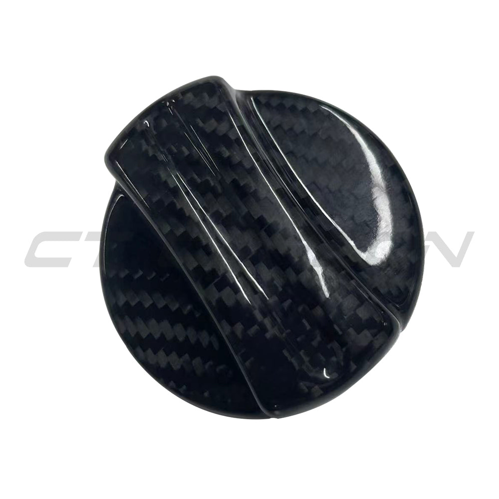 BMW 2010+ carbon fiber fuel cap cover by CT Carbon, close-up of sleek, textured accessory for vehicle fuel tank.