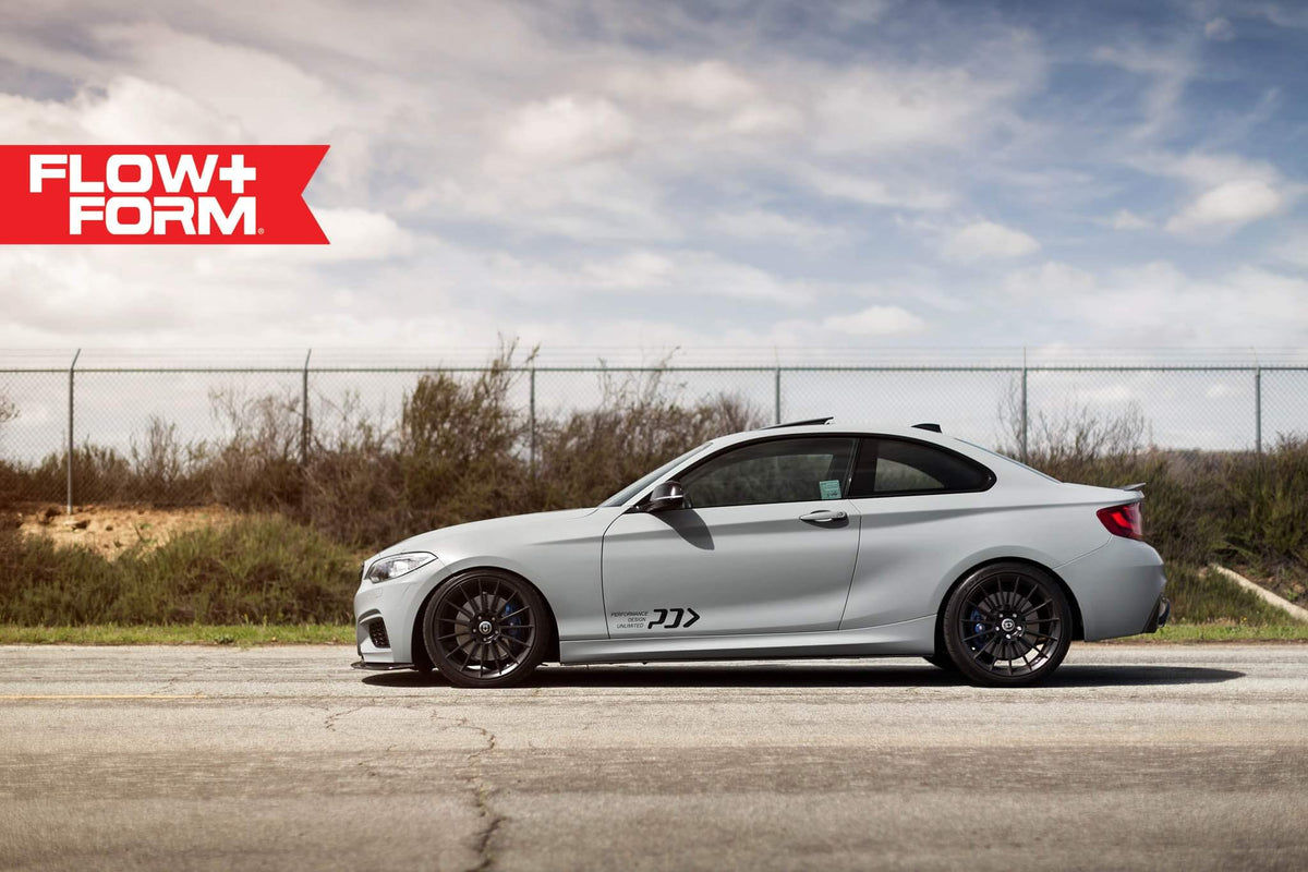HRE PERFORMANCE WHEELS FF15 alloy wheels with a sleek multi-spoke design, shown on a vehicle with a close-up view of the rims.