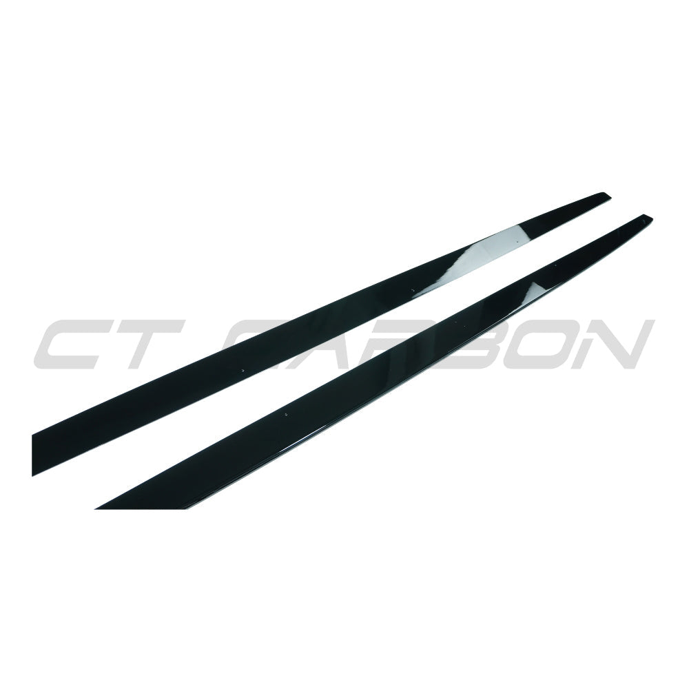 BMW 1 Series E82/E83/E87/E88 side skirts in gloss black from CT Carbon, showing sleek aerodynamic design on a vehicle.