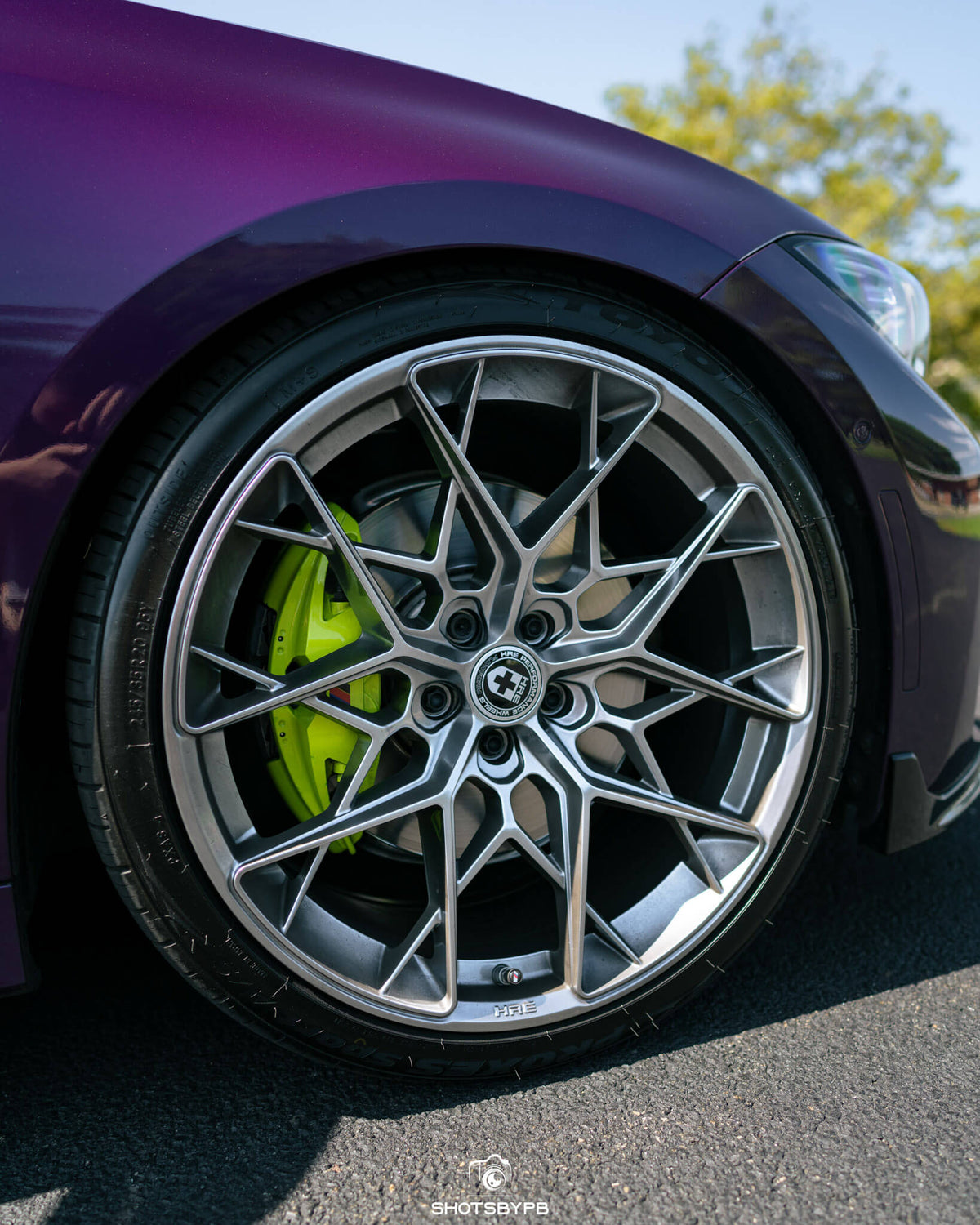 HRE PERFORMANCE WHEELS FF10 alloy wheels with multi-spoke design, shown on a vehicle with a glossy finish and low-profile tires.