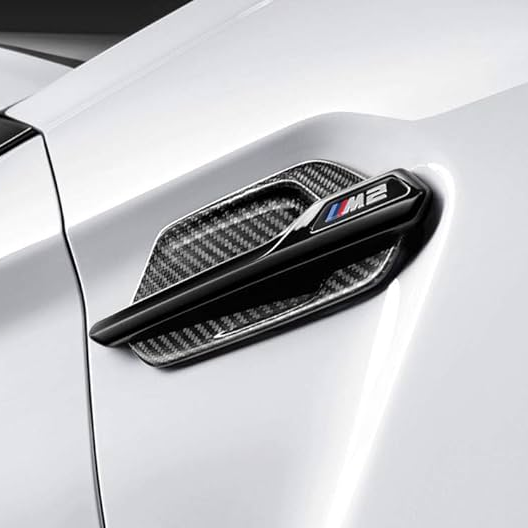 Genuine BMW F87 M2 M Performance carbon side grille air breathers on exterior trim, shown on vehicle close-up.