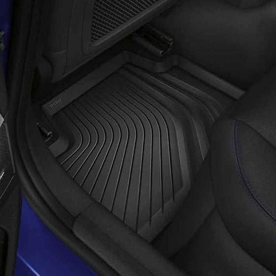 Genuine BMW rubber all weather floor mats for G22 G82 models, durable black mats with textured surface for vehicle protection.