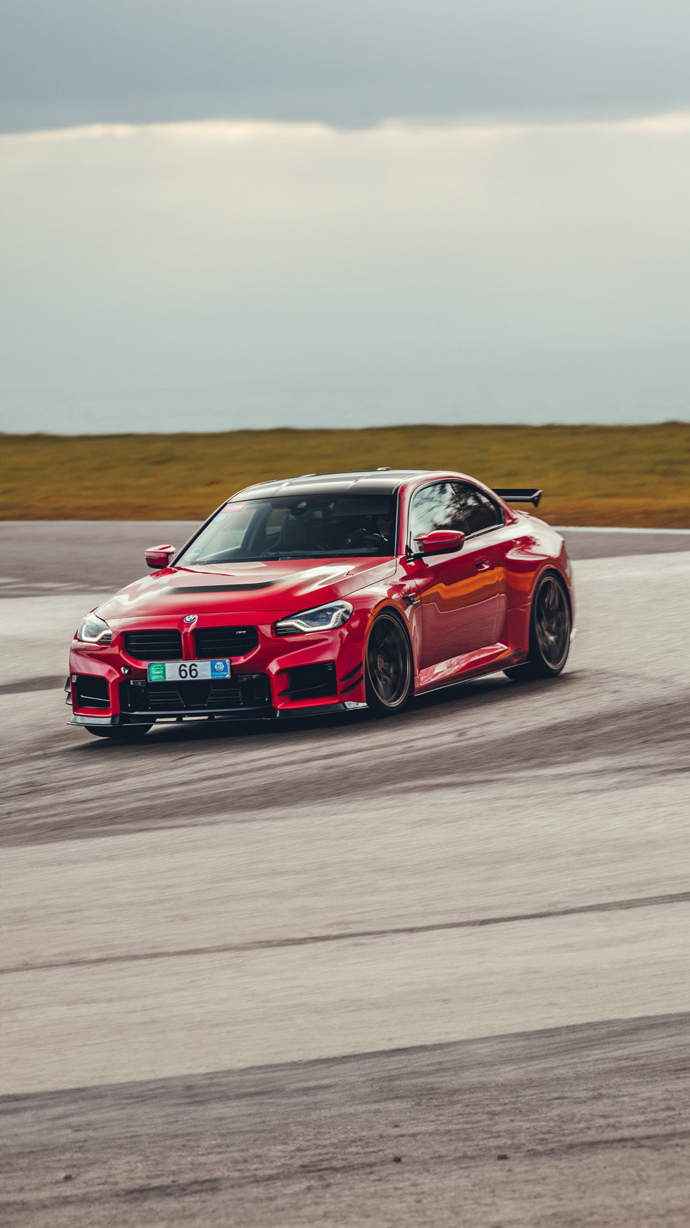 AC Schnitzer BMW M2 G87 front splitter showing aerodynamic carbon fiber design and installation details.