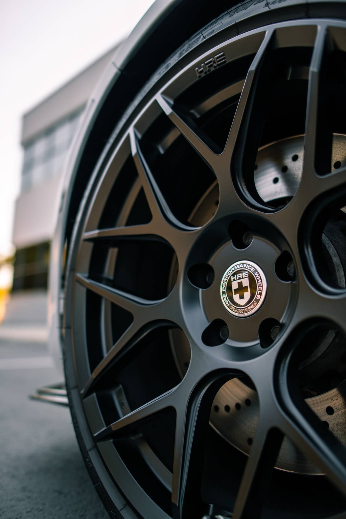 HRE PERFORMANCE WHEELS FF01 wheel with multi-spoke design and silver finish, shown mounted on a vehicle.