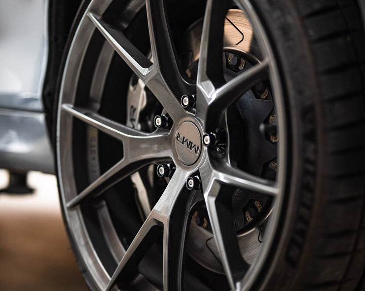 MMX Performance wheel stud and nut conversion kit for BMW and MINI vehicles, featuring six studs and matching nuts.