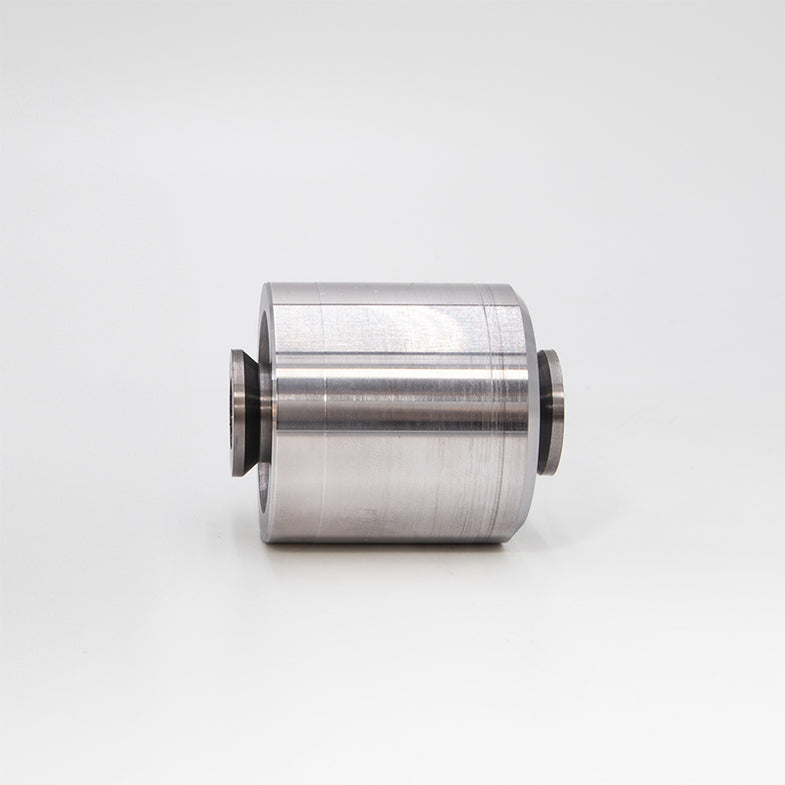 Suspension Secrets solid rear control arm bushes for BMW G87 M2, close-up of black suspension linkage components.