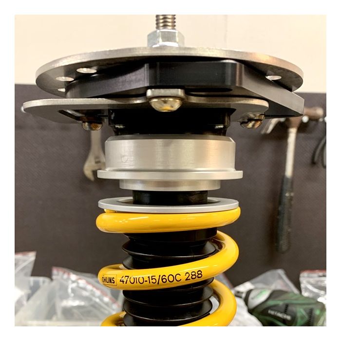 Millway Motorsport adjustable camber plates for E9X M3 and E82 1M suspension top mounts, showing the metal plates and mounting hardware.