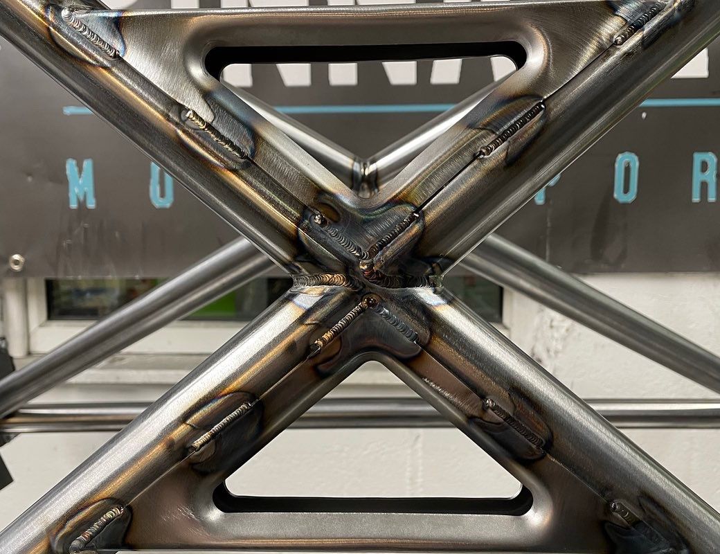 PINNACLE M4 GTS Style T45 Half Roll Cage installed in a car, showcasing durable steel tubing and safety structure for motorsport vehicles.