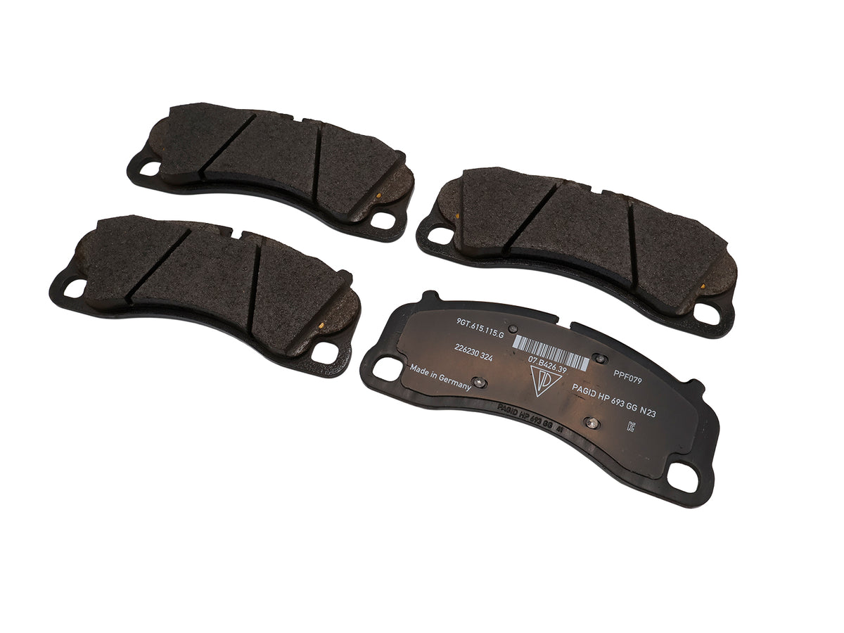 Genuine Porsche front brake pads for Porsche 718 Cayman GT4, showing the branded brake pad set with metallic backing plates.