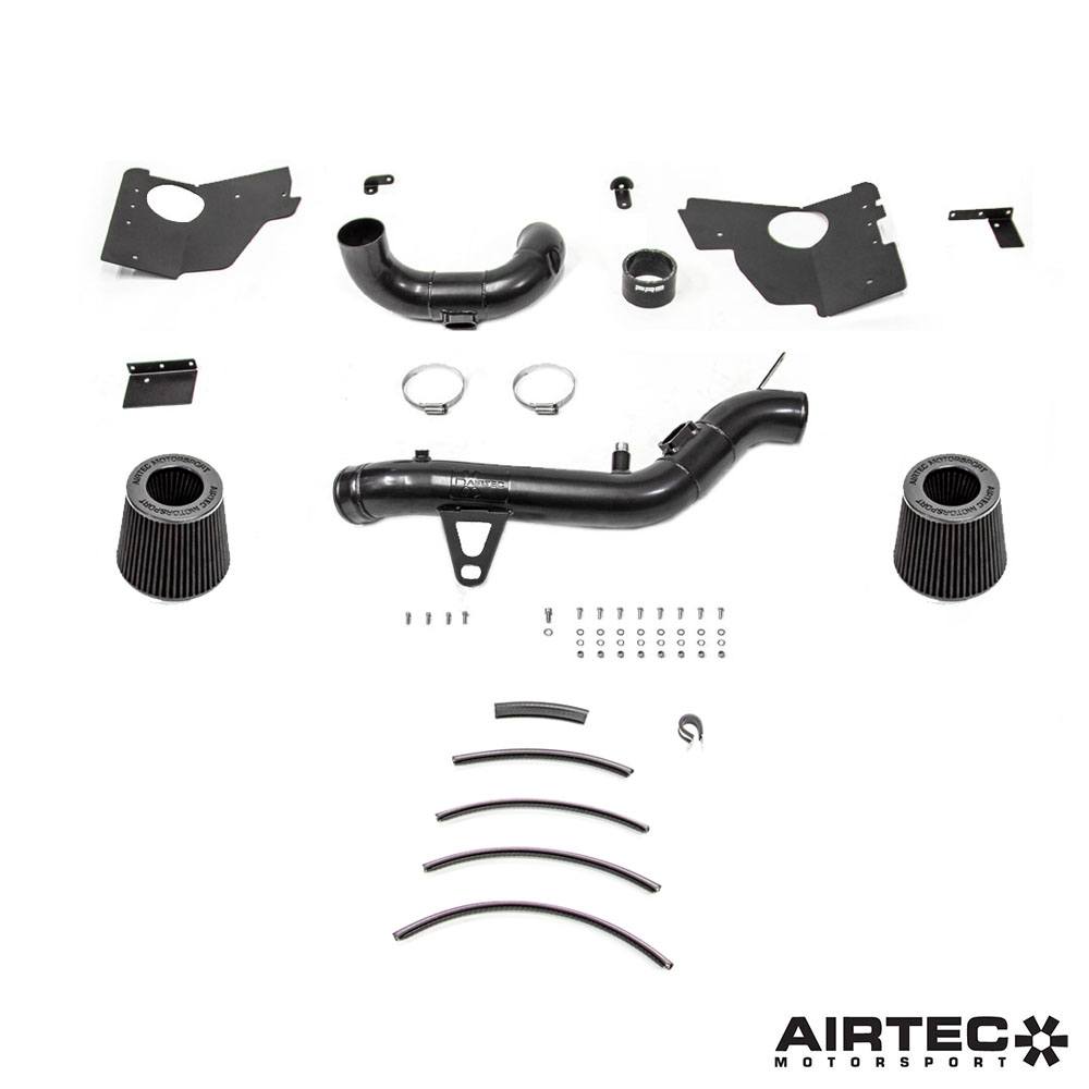 Airtec Motorsport induction kit installed in a BMW M2 Competition, M3, and M4 engine bay, showcasing performance air intake components.