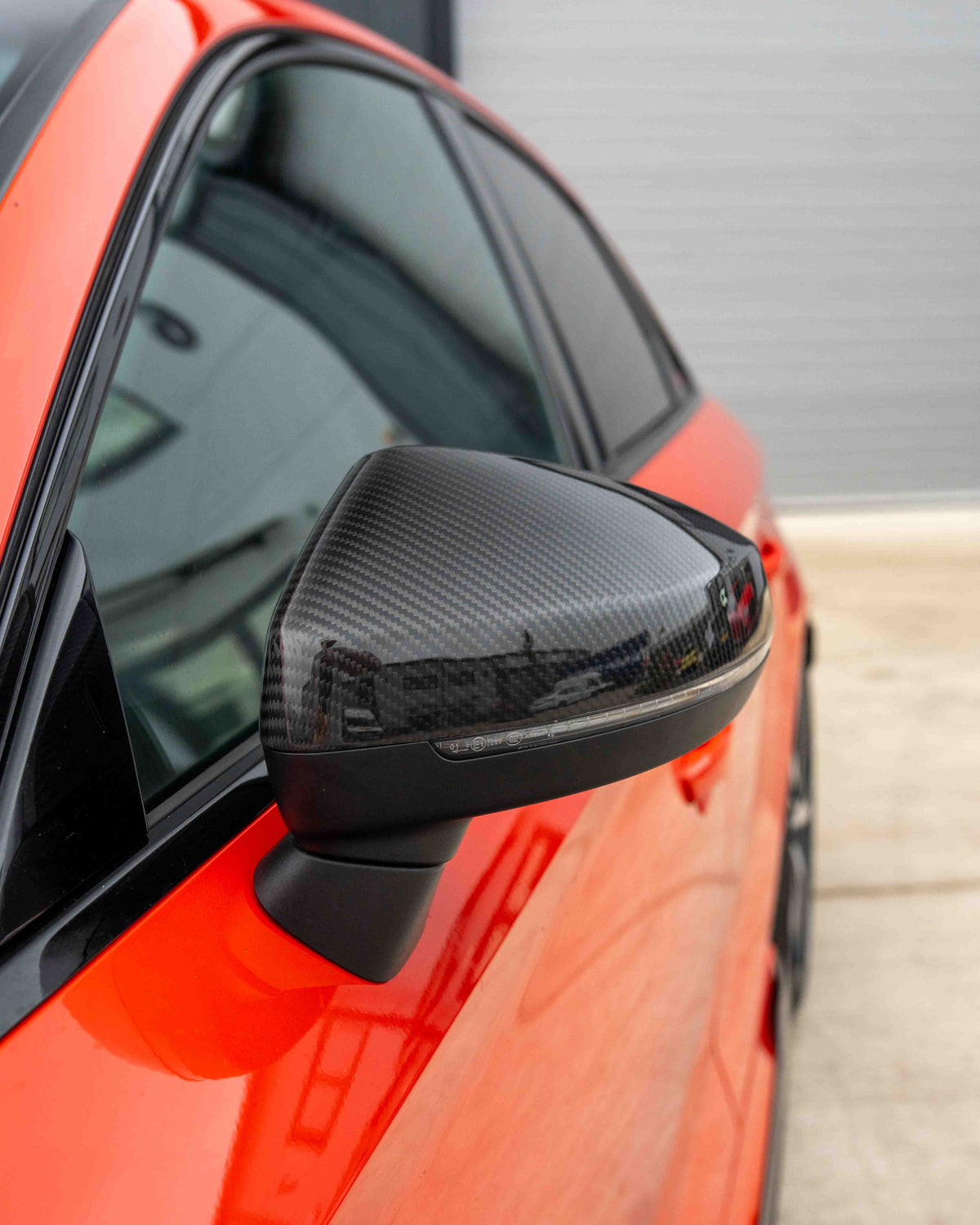 Audi A3, S3, RS3 8V carbon fiber mirror covers with lane assist from CT Carbon, showcasing sleek, glossy carbon fiber finish.