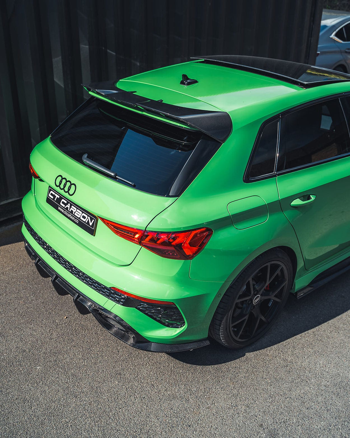Carbon fiber diffuser for Audi RS3 8Y Sportback 2022-2024 by CT Design, showing sleek aerodynamic design and textured carbon finish.