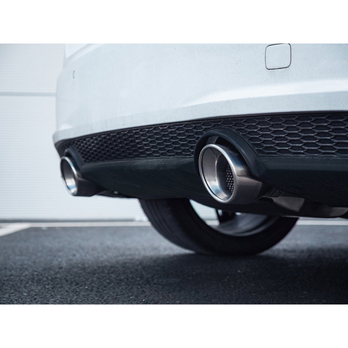 Cobra Sport cat back exhaust installed on Audi TT Mk3 2.0 TFSI FWD, featuring a sleek stainless steel design and performance-enhancing features.