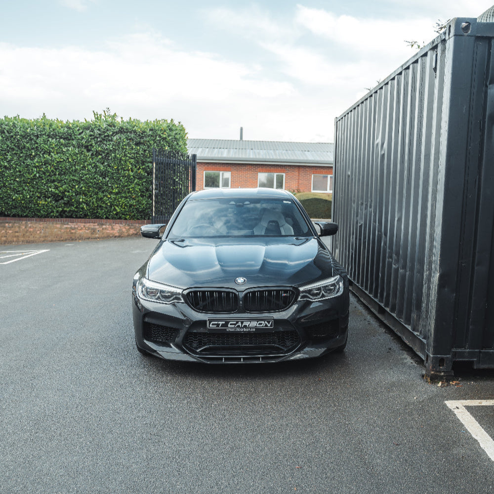 Black carbon fiber splitter for BMW F90 M5 and M5 Competition Pre-LCI by CT Carbon, showcasing its aerodynamic design.