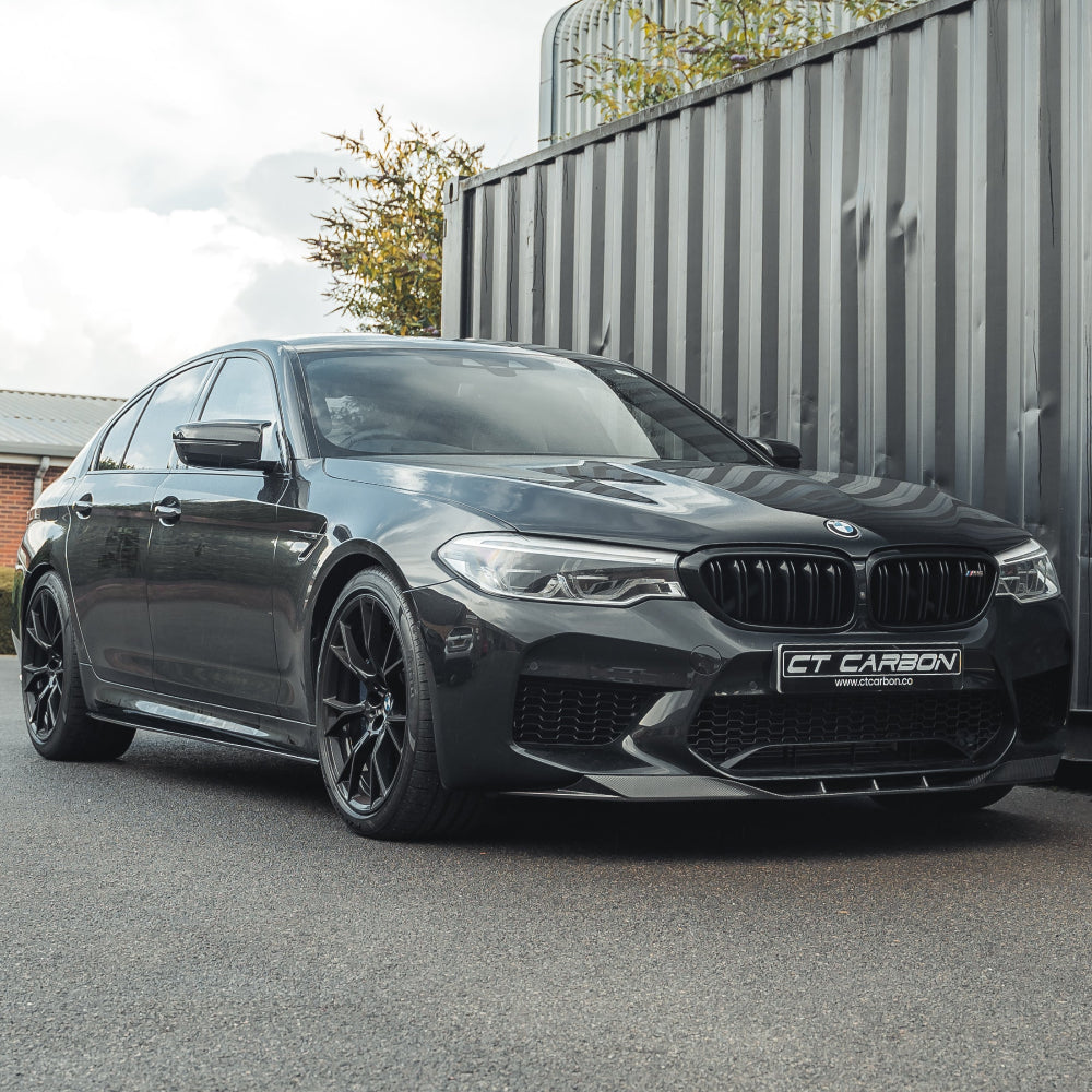 Black BMW F90 M5 Competition V3 carbon fiber splitter by CT Carbon installed on the front of the car.