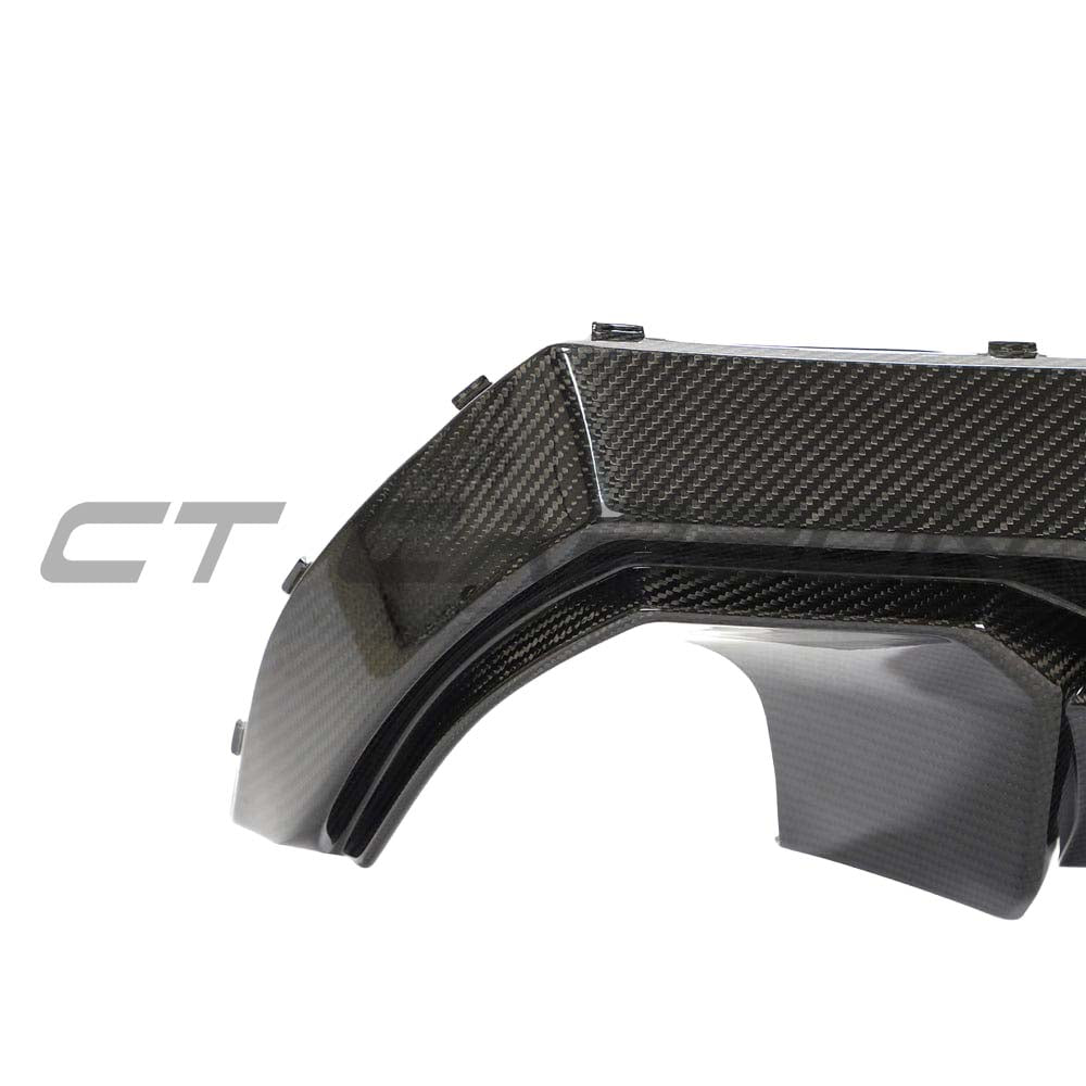BMW 1 Series F40 carbon fiber diffuser by CT Design, showcasing sleek aerodynamic design and textured carbon fiber surface.