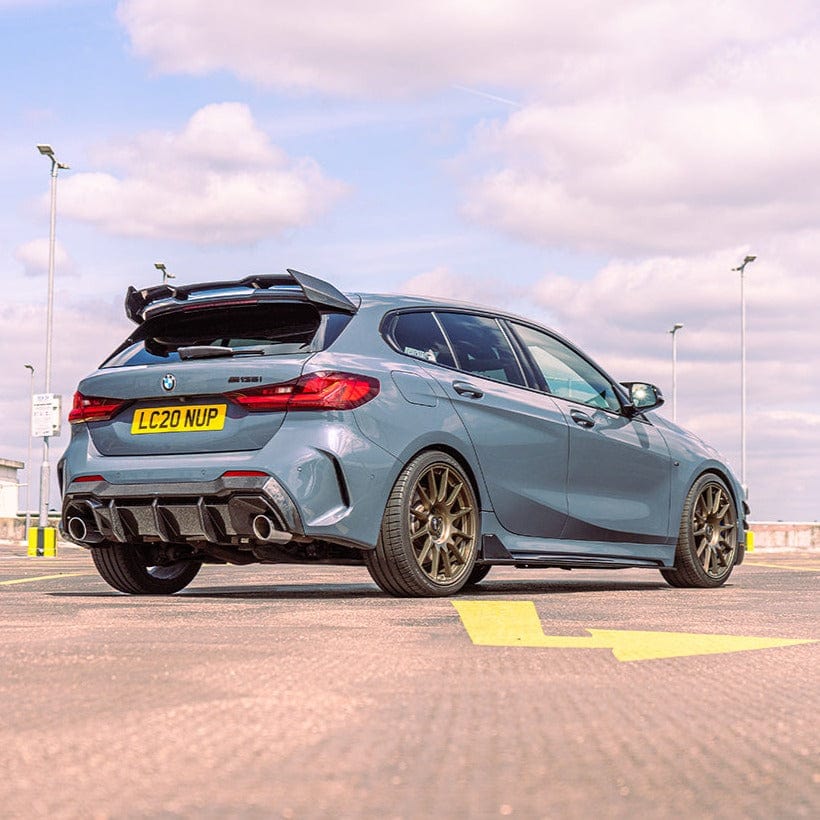 BMW 1 Series F40 carbon fiber diffuser by CT Carbon, showcasing its sleek design and textured carbon fiber surface.