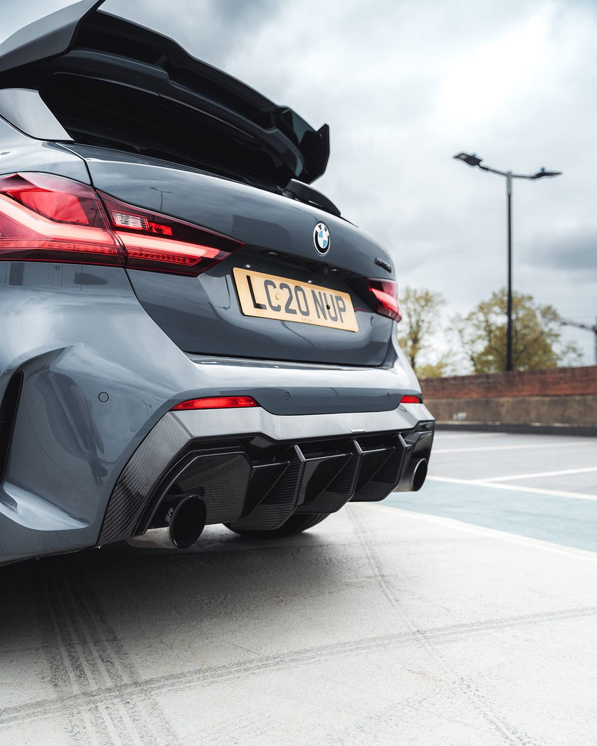 BMW 1 Series F40 carbon fibre diffuser by CT Carbon, showcasing sleek aerodynamic design and textured carbon finish.