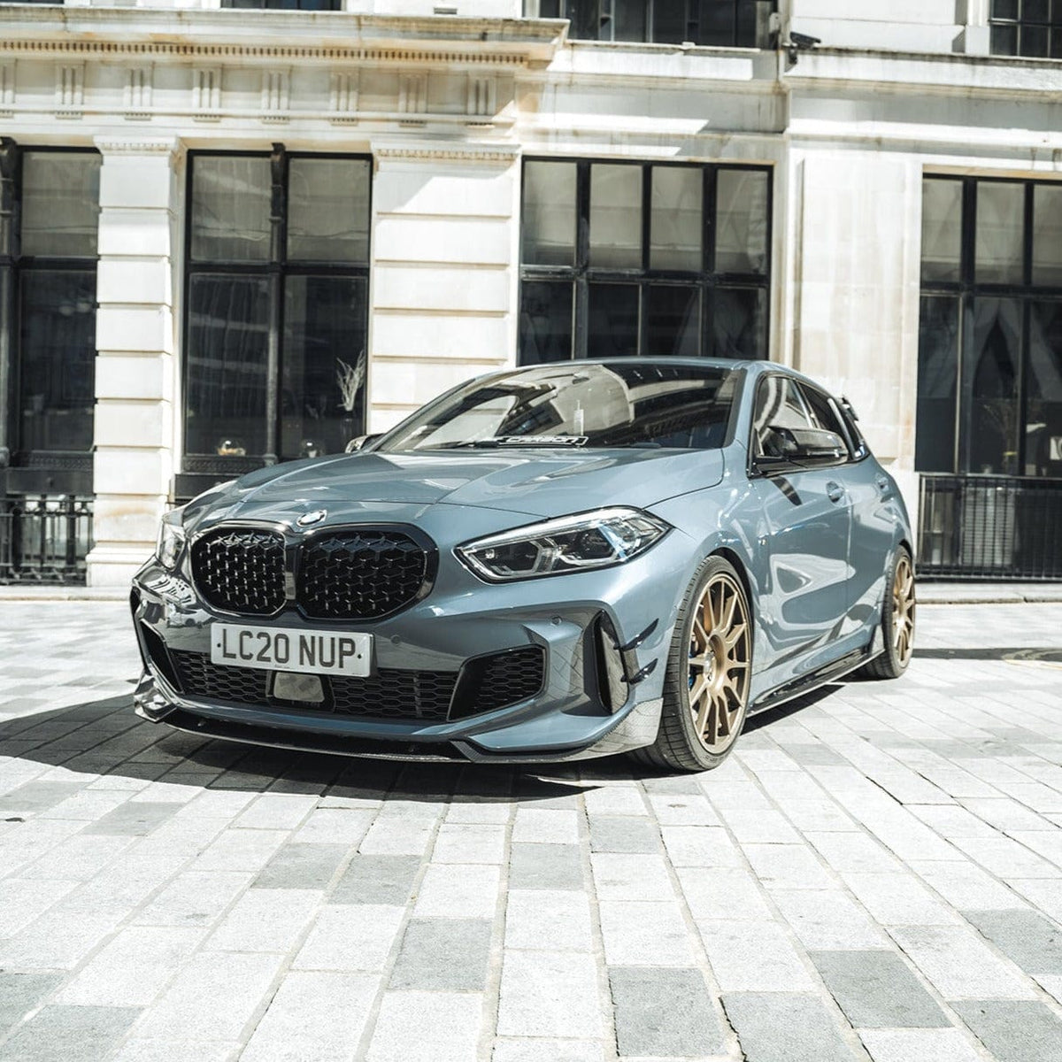 BMW 1 Series F40 carbon fibre splitter by CT Design, showing sleek black finish and aerodynamic design on the front of the car.