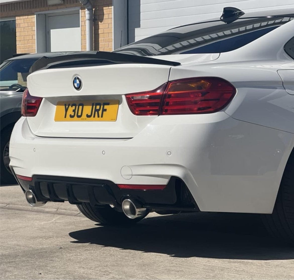 BMW 4 Series Gran Coupe F36 CT Carbon V5 gloss black M-style spoiler installed on the rear of the vehicle.