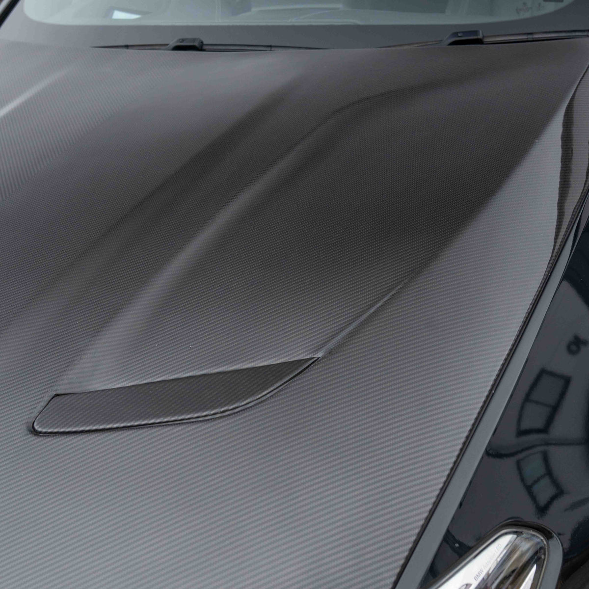 BMW F90 M5 and G30 5 Series carbon fiber bonnet by CT Carbon, showing the lightweight, glossy carbon fiber surface and sleek design.