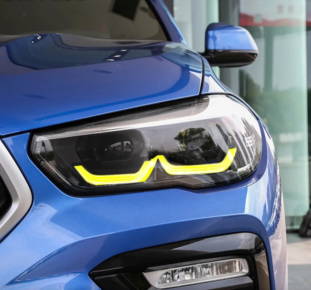 BMW F95 X5M yellow adaptive DRL module set by CT Carbon, showing two bright yellow LED daytime running light modules.