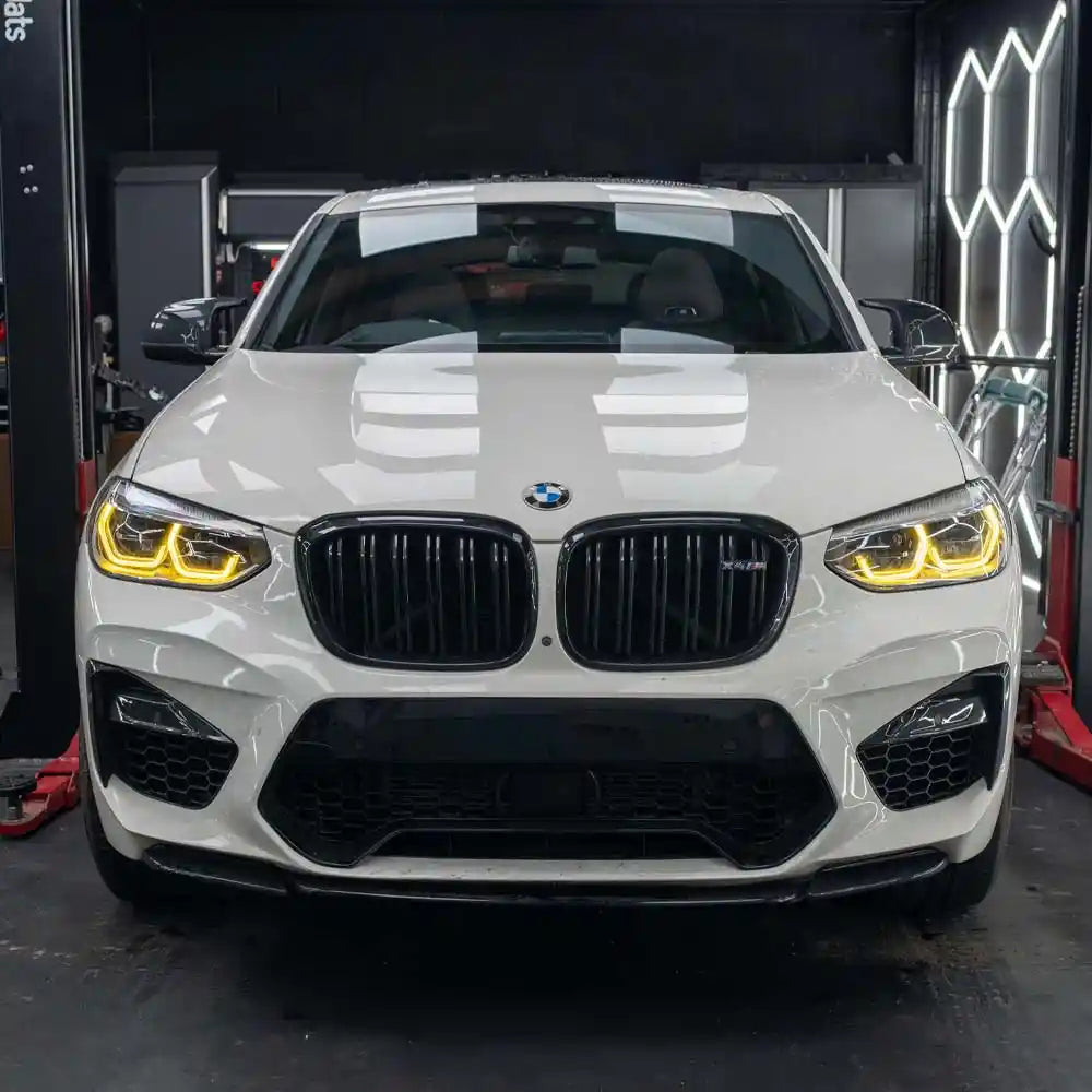 BMW F98 X4M Pre-LCI yellow adaptive DRL module set by CT Carbon, showing the bright yellow daytime running lights.