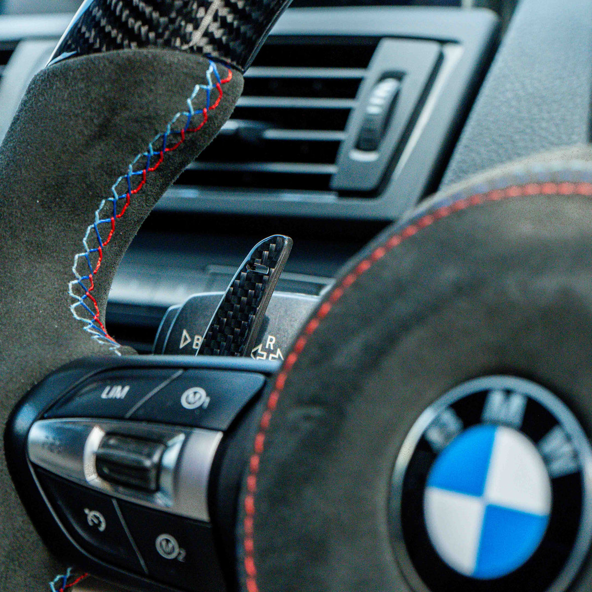BMW Fxx carbon fiber magnetic shifter paddles by CT Carbon, showcasing sleek, lightweight racing-style accessories for enhanced driving.
