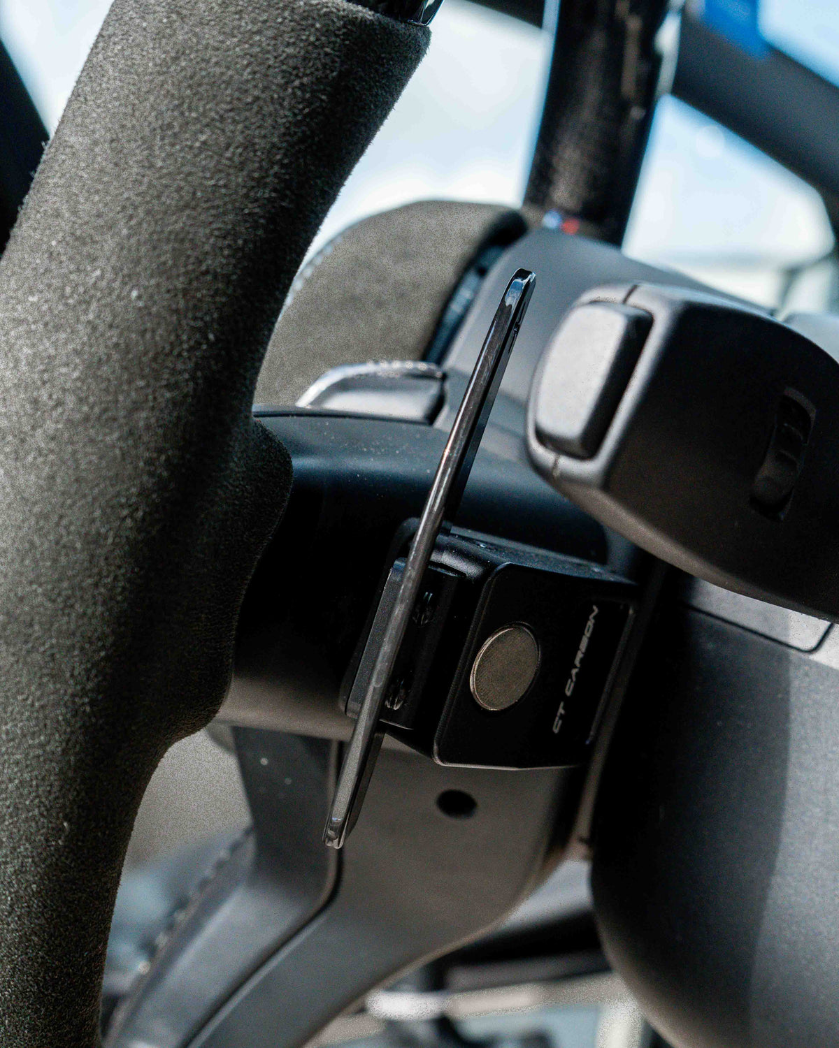 BMW Fxx carbon fiber magnetic shifter paddles by CT Carbon, close-up of sleek, lightweight racing-style car accessories.