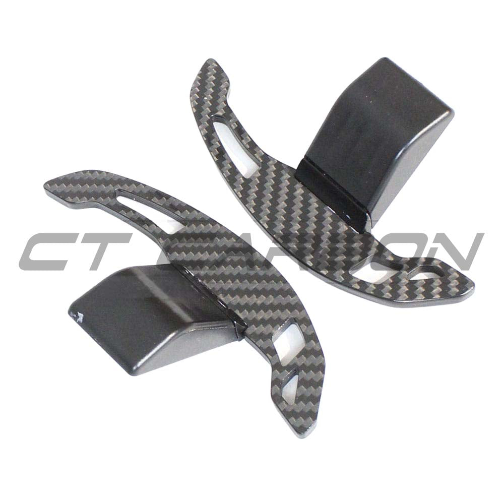 BMW Fxx carbon fiber shifter paddles by CT Carbon, close-up view showing sleek black finish and textured surface.