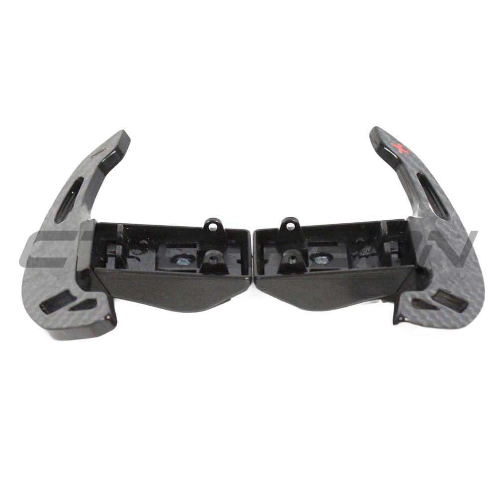 BMW Fxx carbon fiber shifter paddles by CT Carbon, showing sleek, lightweight design with textured carbon fiber surface and ergonomic shape.