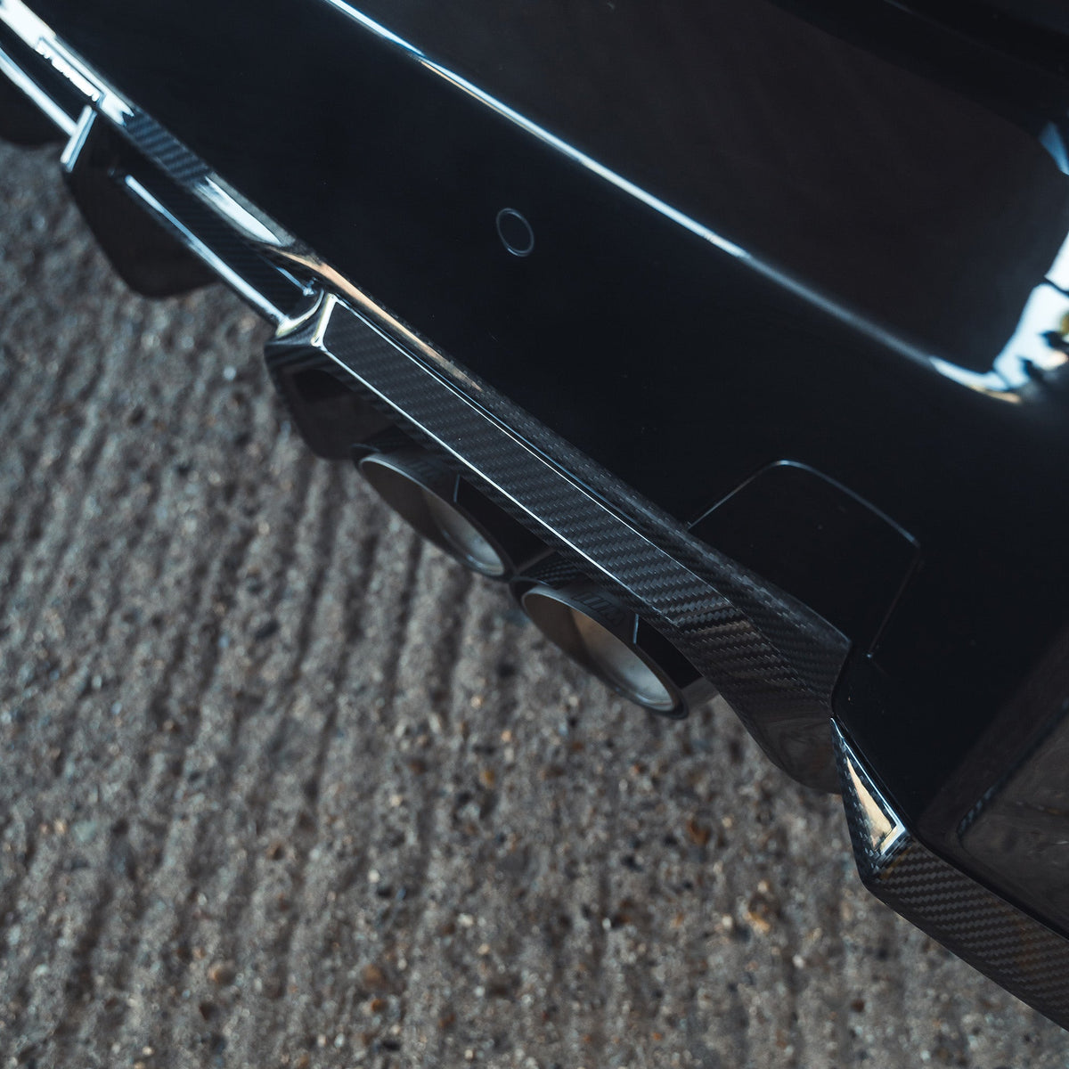 BMW G87 M2 carbon fibre diffuser by CT Design, showcasing sleek, textured carbon fiber with aerodynamic design features.