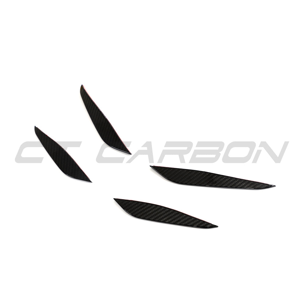 BMW G87 M2 carbon fiber front bumper canards by CT Carbon, close-up view showing lightweight aerodynamic accessories.