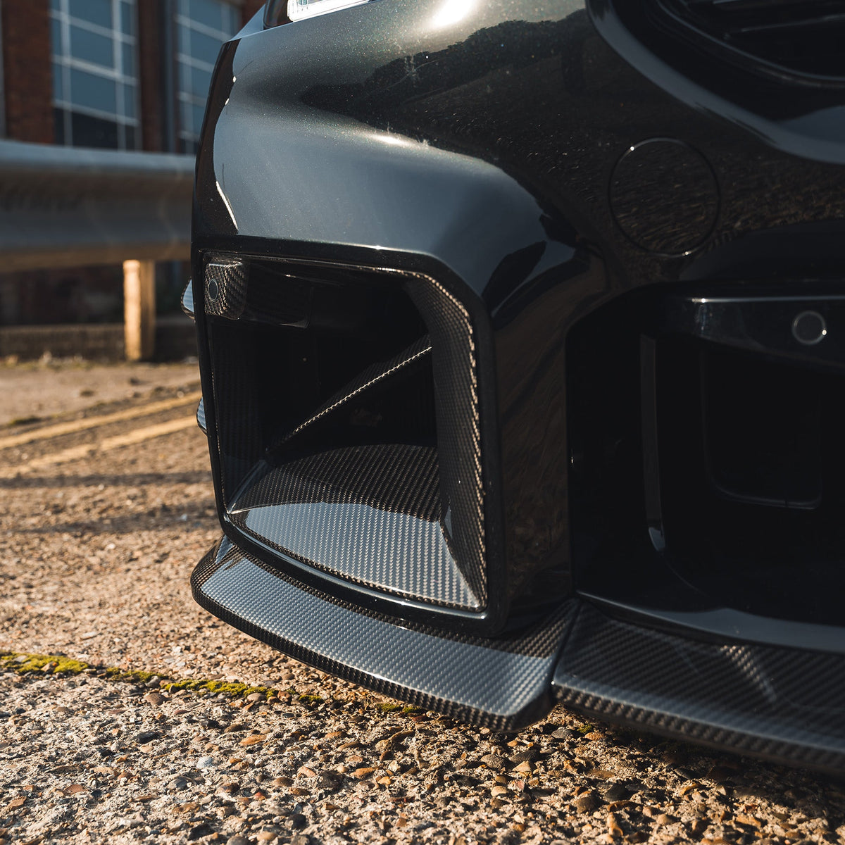 BMW G87 M2 carbon fibre front ducts by CT Carbon, showcasing lightweight, aerodynamic accessories with a sleek carbon fibre finish.