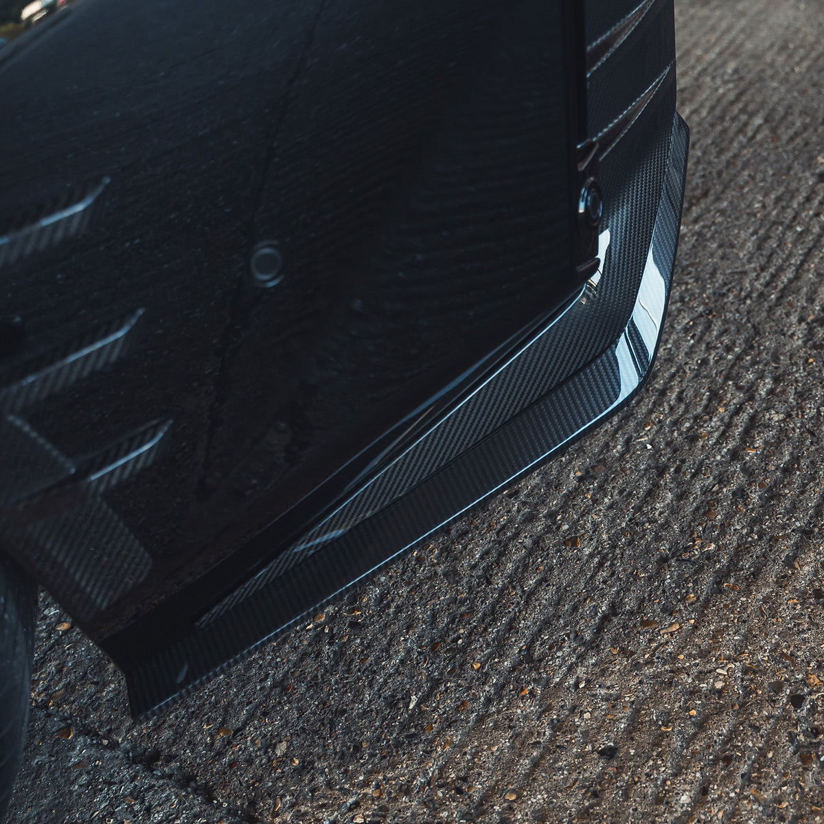 BMW G87 M2 carbon fiber rear bumper corners by CT Design, close-up showing sleek, lightweight carbon fiber finish for sporty aesthetics.