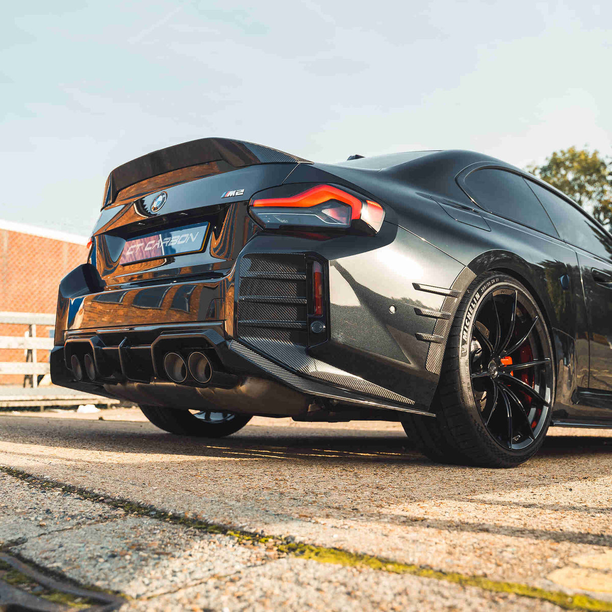 BMW G87 M2 and G42 2 Series carbon fibre spoiler by CT Design, showcasing sleek aerodynamic design on a sports car.