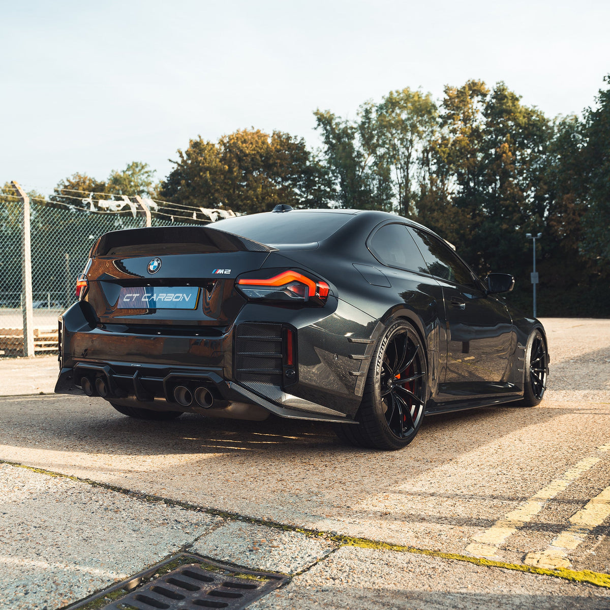 BMW G87 M2 and G42 2 Series carbon fibre spoiler by CT Carbon, showcasing sleek, aerodynamic design on a sporty car.