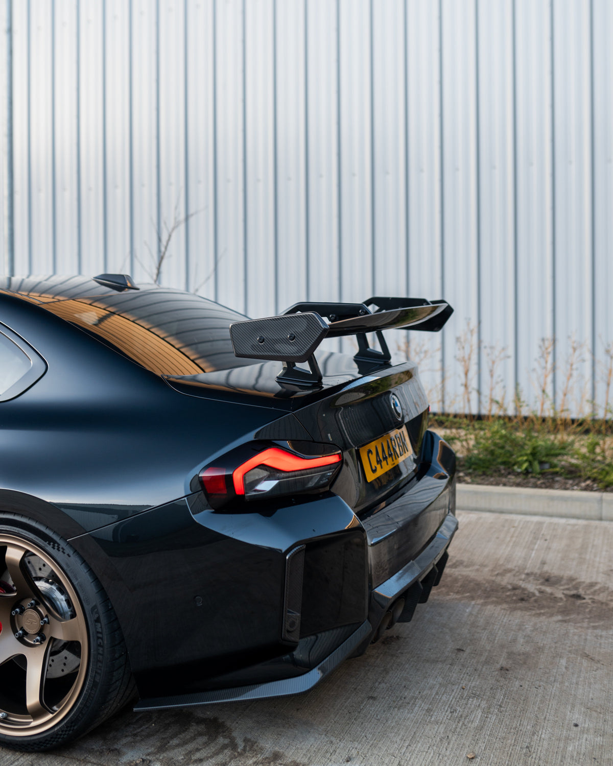 BMW G87 M2 and G42 2 Series carbon fibre swan neck wing spoiler by CT Design, showcasing sleek aerodynamic design.