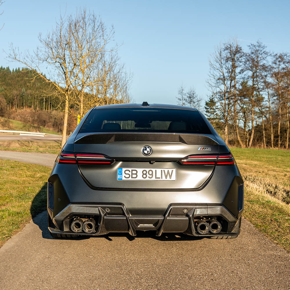 BMW G90 M5 and G60 5 Series 2023 carbon fibre spoiler by CT Carbon, showcasing sleek aerodynamic design on a dark vehicle.