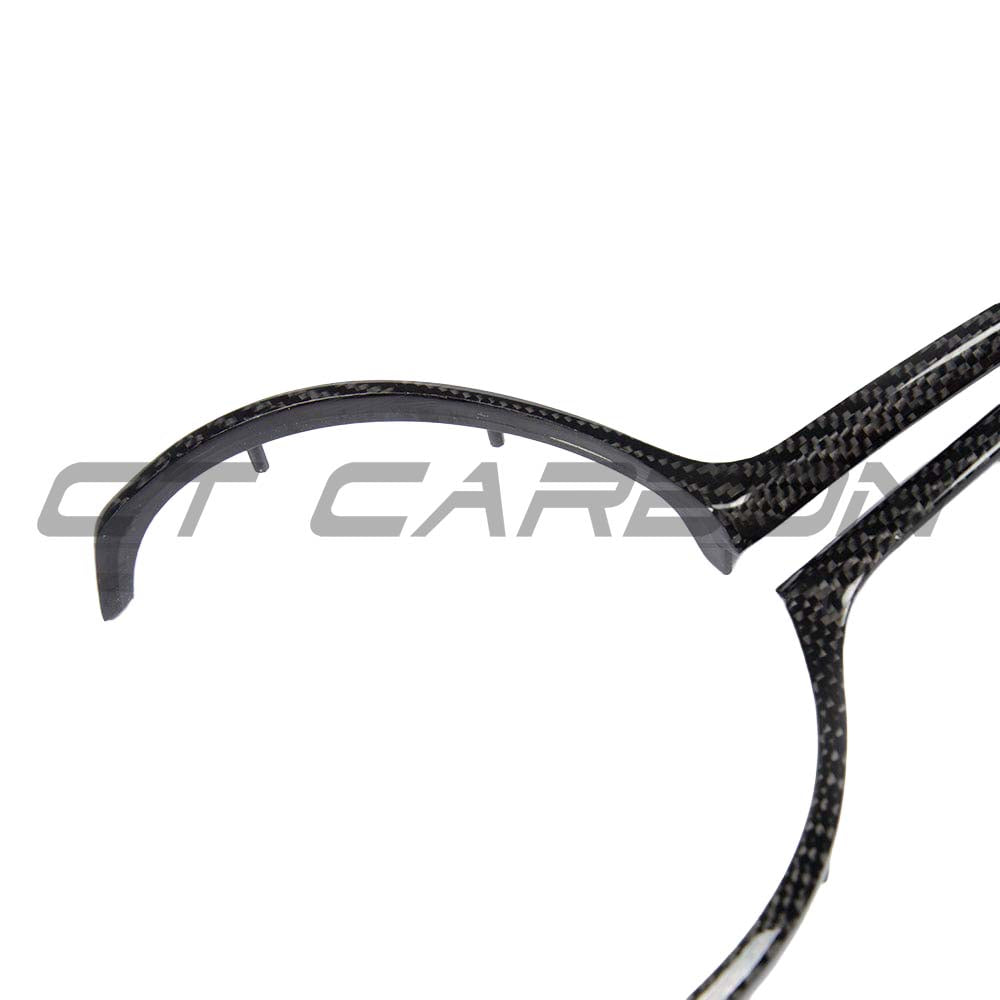BMW M Fxx carbon fiber steering wheel trim by CT Carbon, showing close-up of sleek, glossy black carbon fiber accents on the steering wheel.