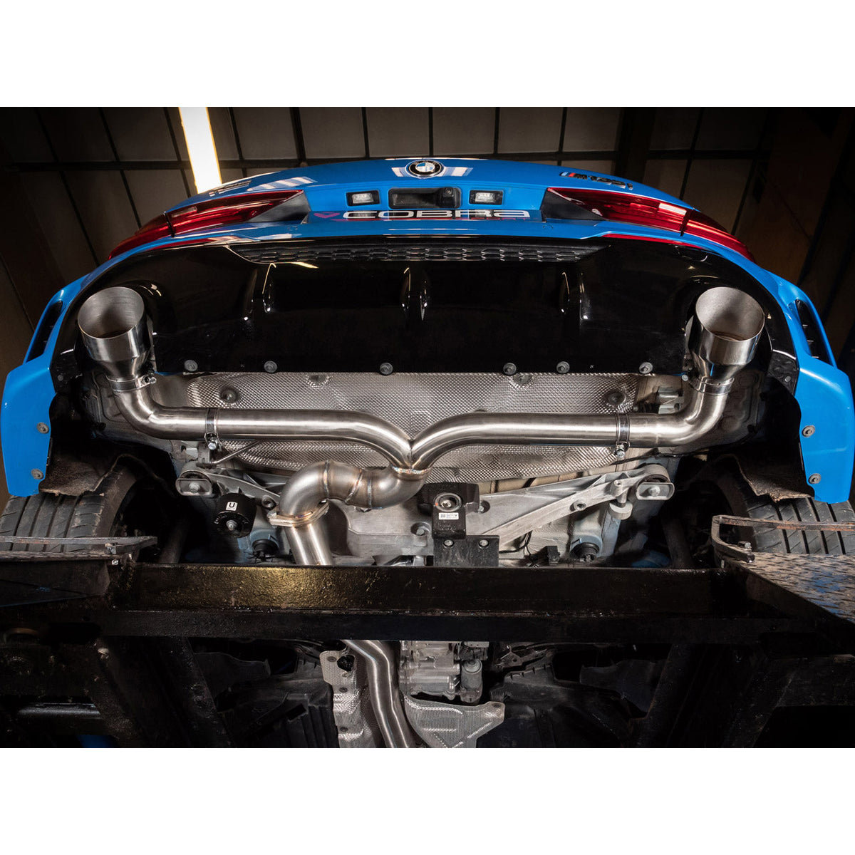 Cobra Sport turbo back exhaust for BMW M135i F40, Venom Race Performance exhaust system with polished metal finish and dual tailpipes.
