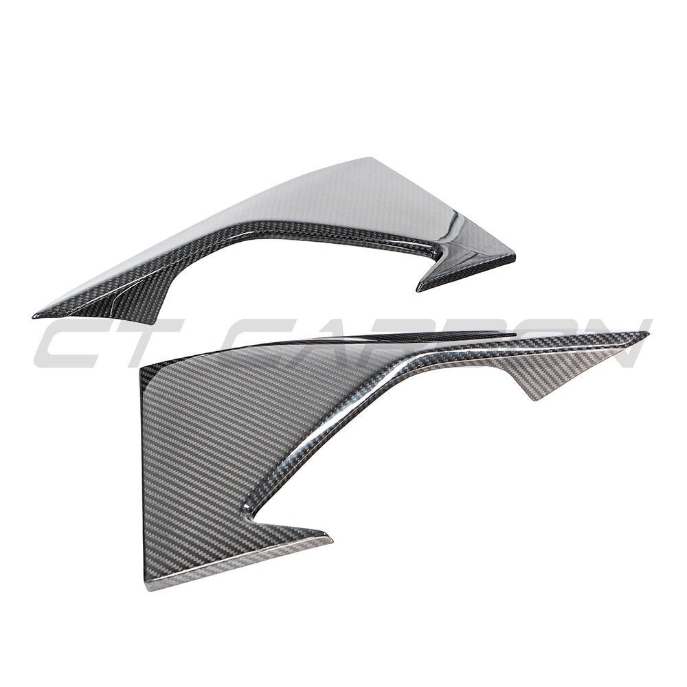 BMW F87 M2 carbon fiber front bumper corner kit by CT Carbon, showcasing lightweight, glossy carbon fiber components on the car.