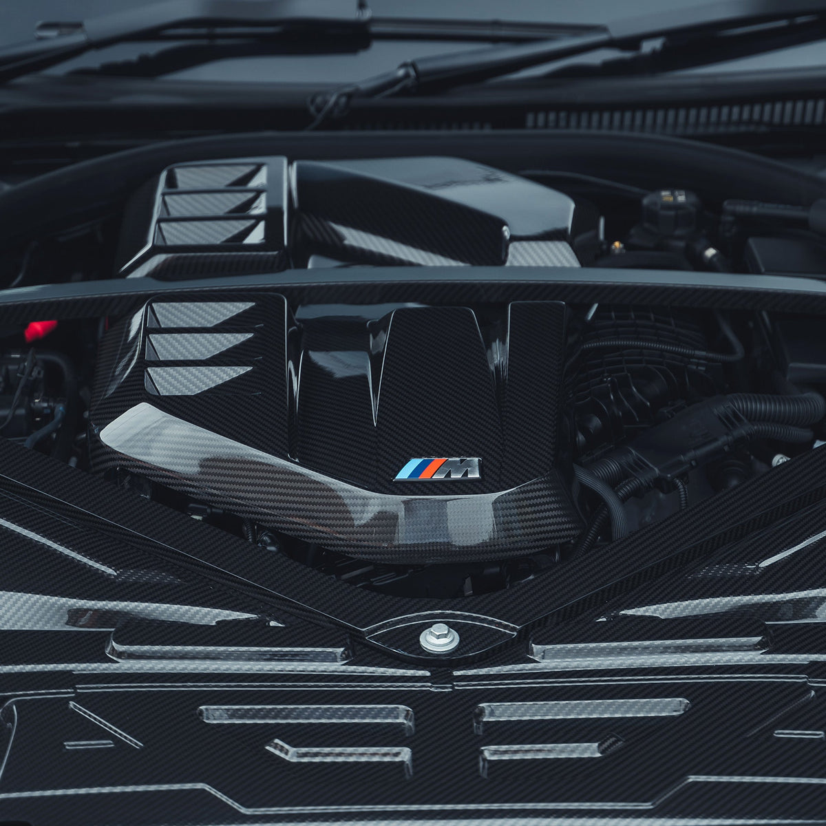 BMW M2, M3, M4 G87/G80/G81/G82/G83 carbon fiber engine cover by CT Carbon, showing sleek, lightweight exterior design.