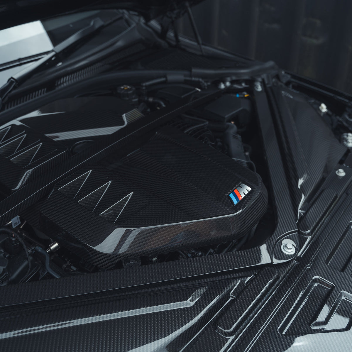 BMW M2, M3, M4 G87/G80/G81/G82/G83 carbon fibre engine cover by CT Carbon, showcasing sleek, lightweight automotive accessories.