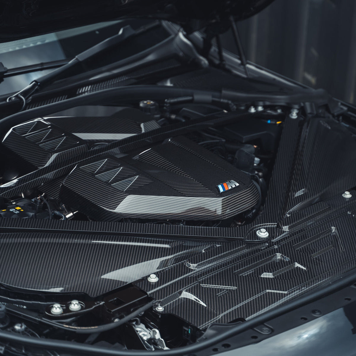BMW M2, M3, M4 G87, G80, G81, G82, G83 Carbon Fibre Engine Dress Up Kit by CT Carbon, showing sleek carbon fiber parts.