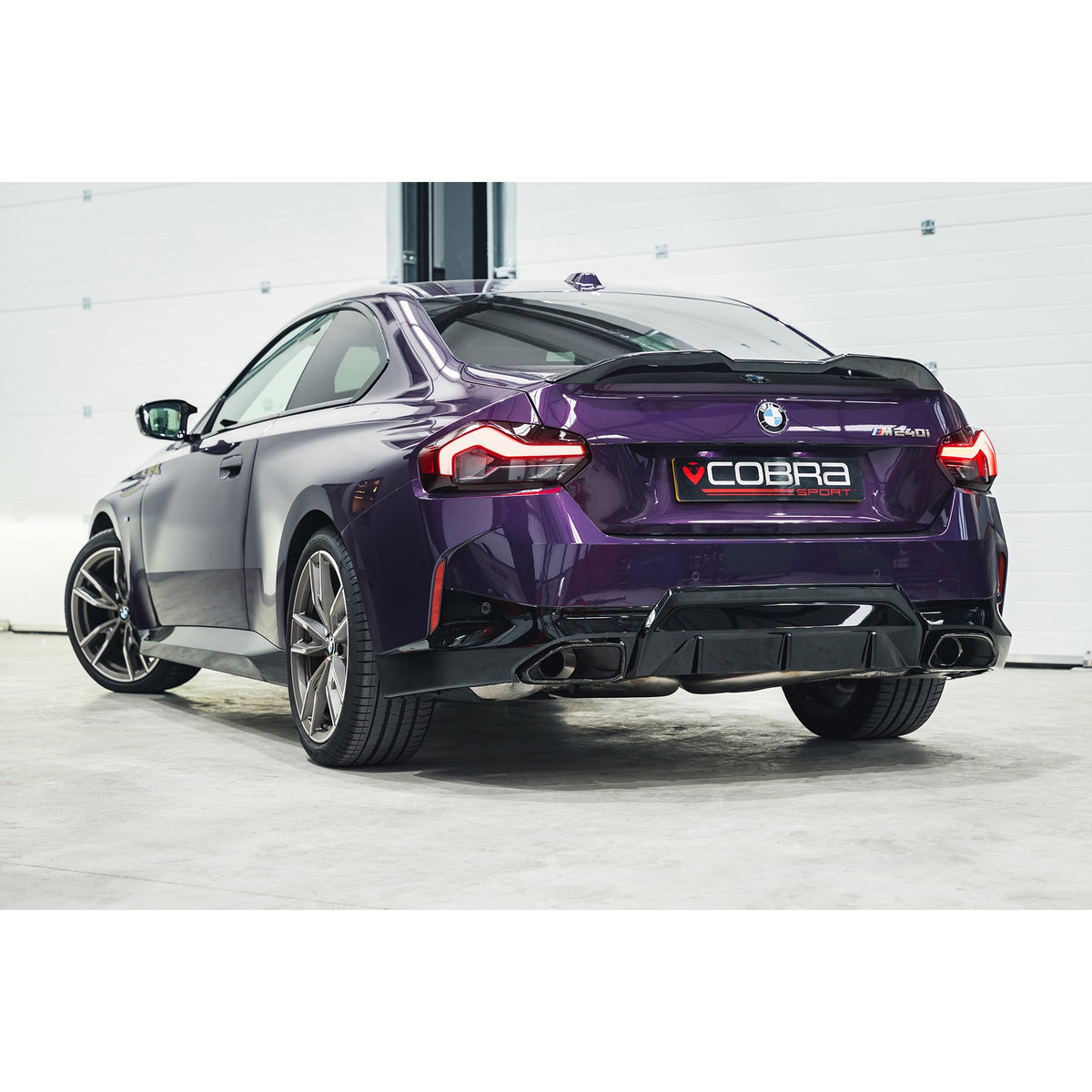 Cobra Sport BMW M240i G42 Venom Race rear axle back exhaust with back box delete, fitted on the car showing the polished tips.